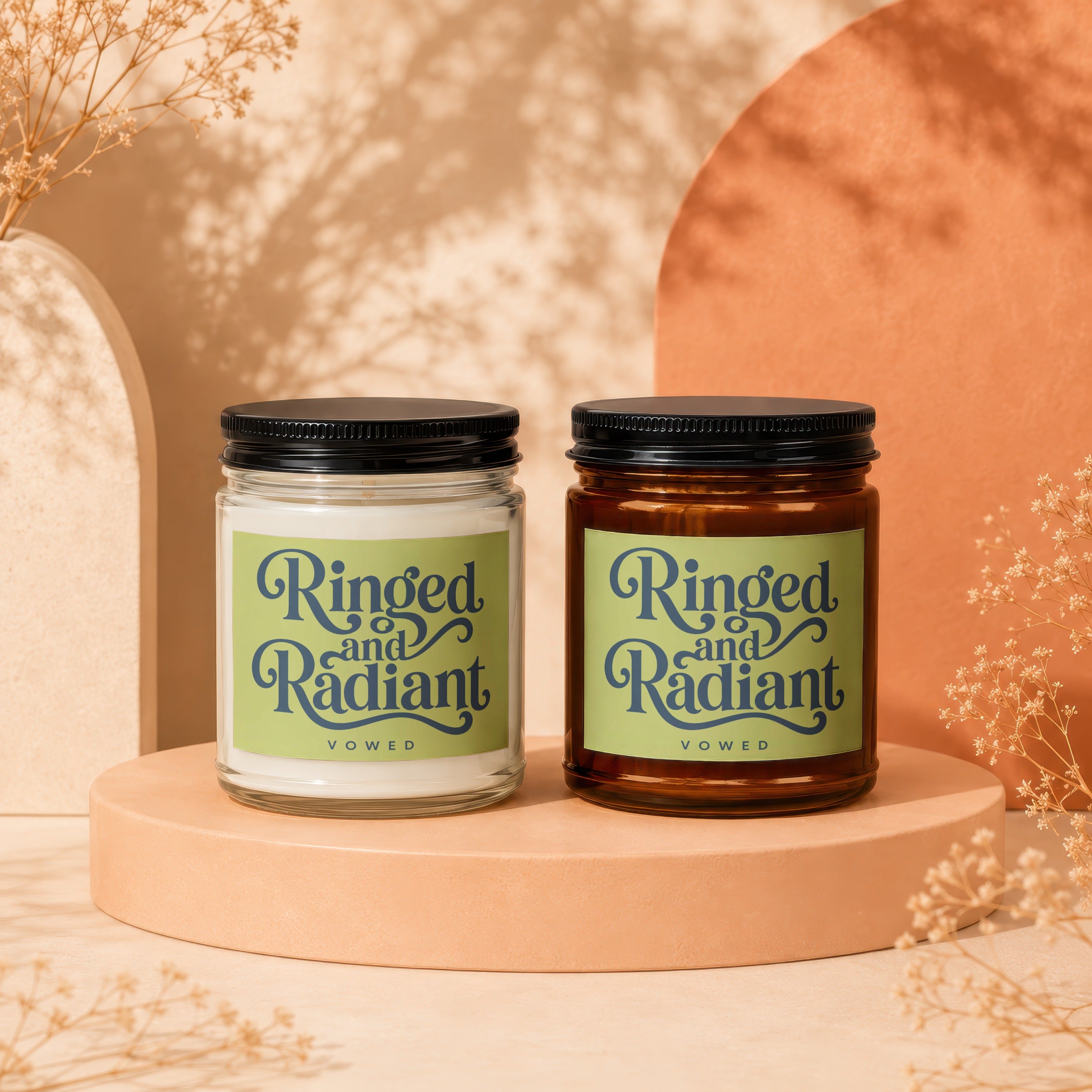 Two scented candles, one clear, one amber, with "Ringed and Radiant VOWED" labels.