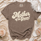 Brown t-shirt with "Mother of the Groom!" text, styled with pearls and a rose.