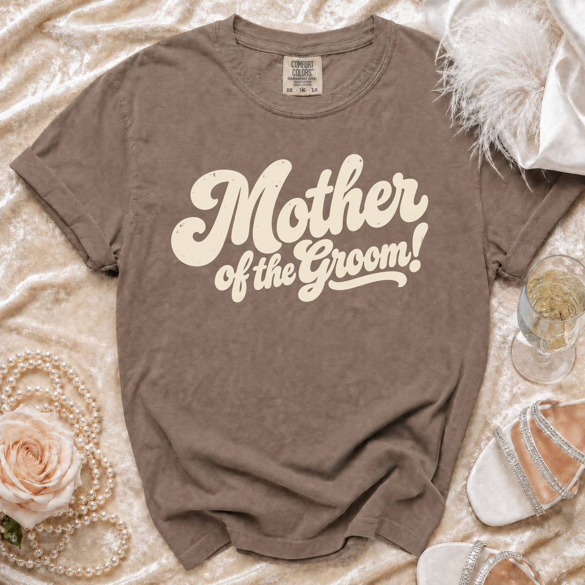 Brown t-shirt with "Mother of the Groom!" text, styled with pearls and a rose.