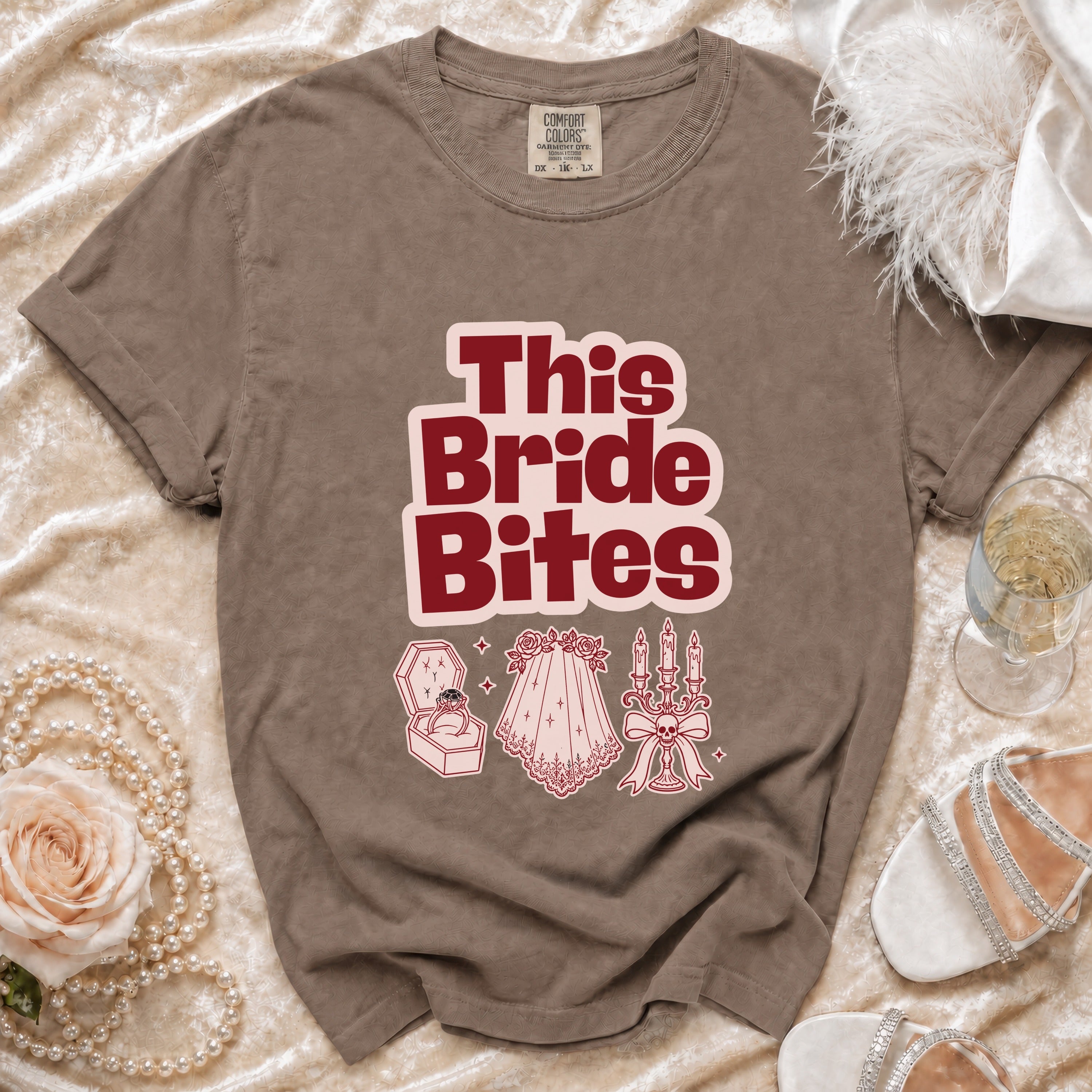 Brown t-shirt with "This Bride Bites" graphic and wedding icons.