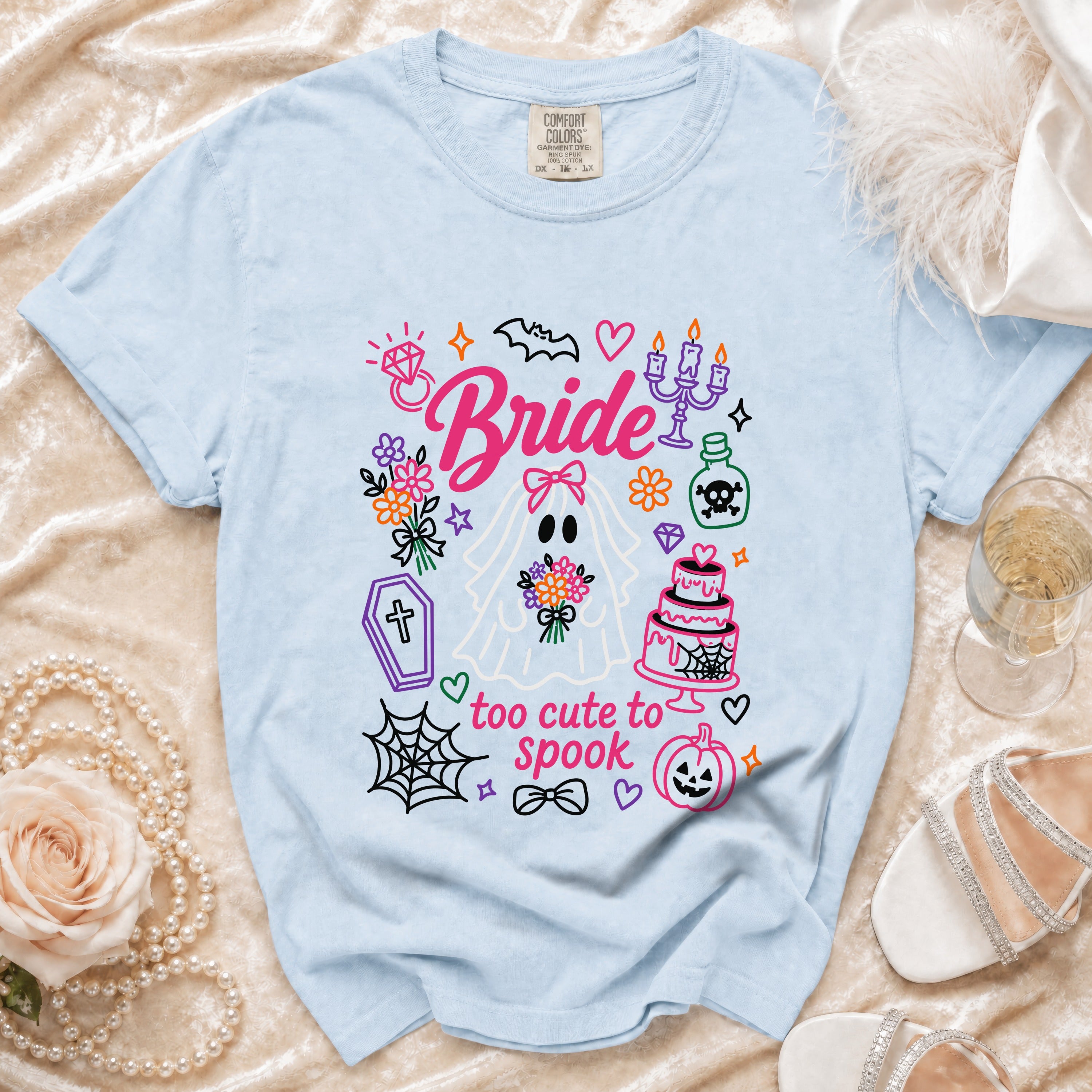 Light blue t-shirt with "Bride" and "too cute to spook" Halloween graphics.