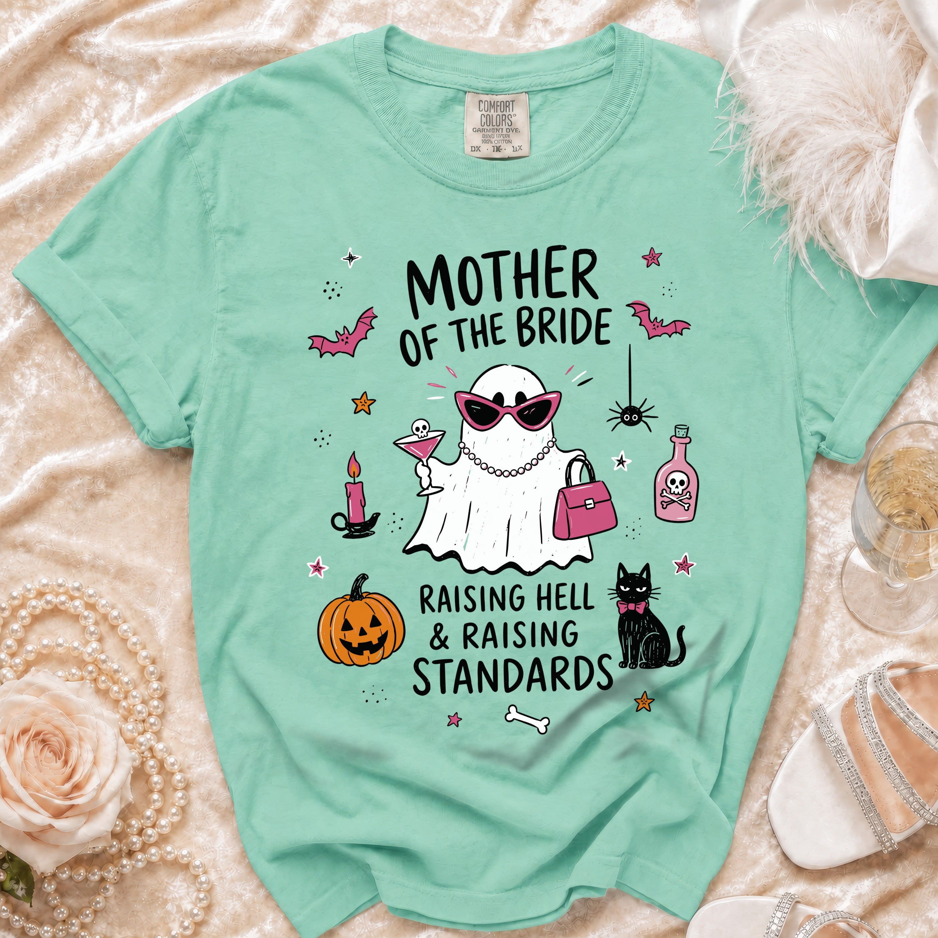 Mint green t-shirt with "Mother of the Bride" graphic featuring a ghost and festive elements.