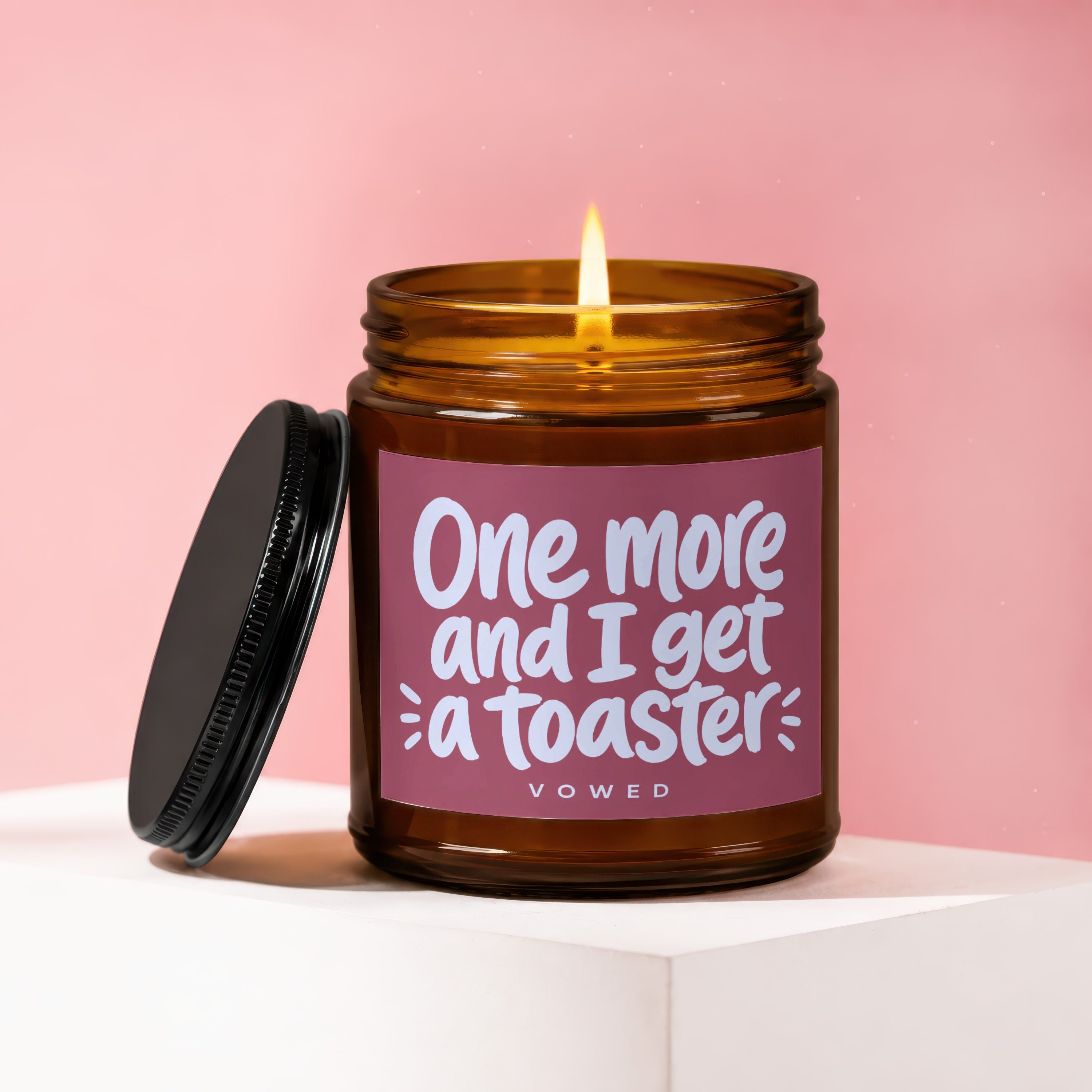 Amber candle with lit wick, "One more and I get a toaster" text.