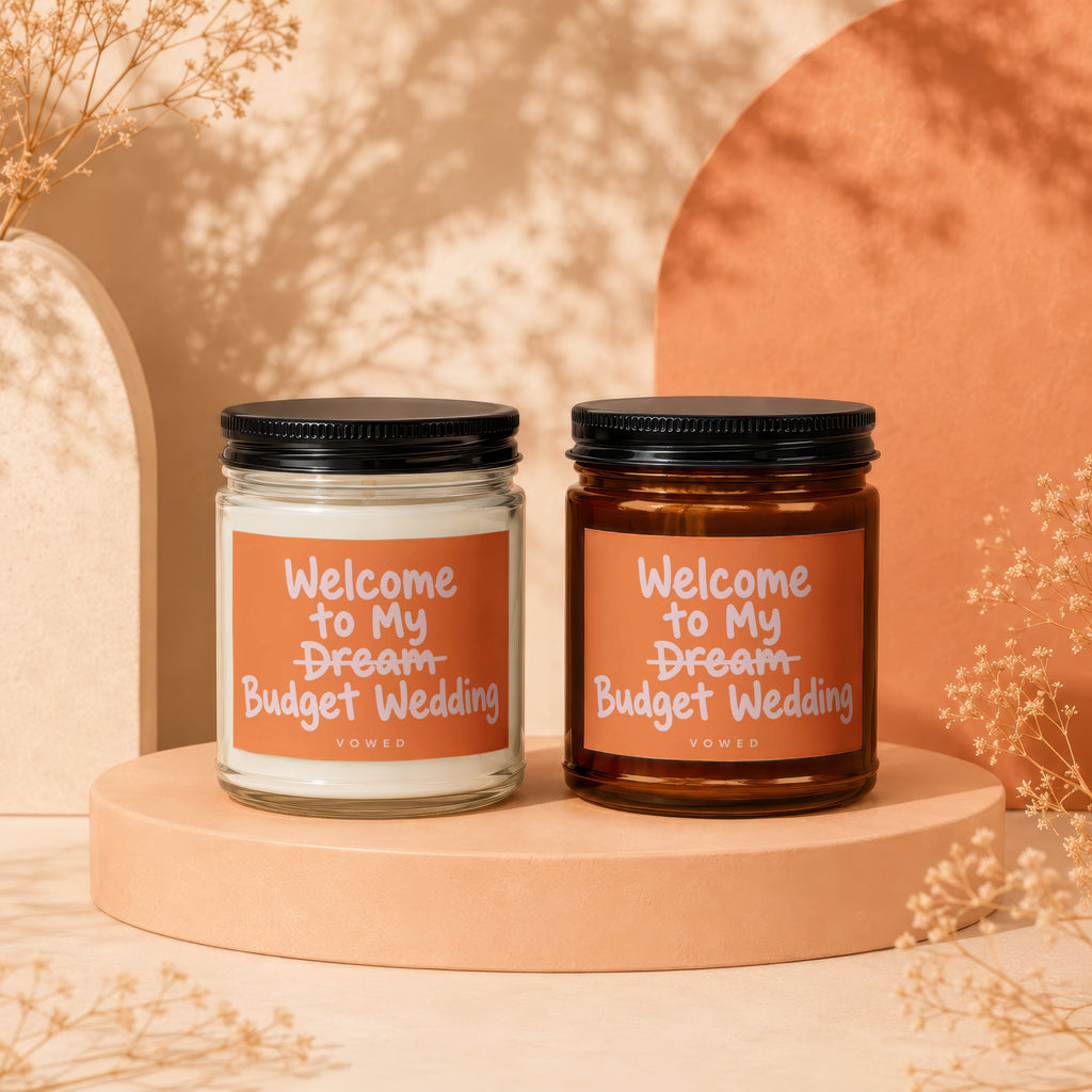 Two scented candles with labels that read "Welcome to My Dream Budget Wedding."