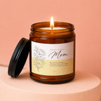 Amber glass candle with lit flame, reads "For My Other Mom" and wedding message.