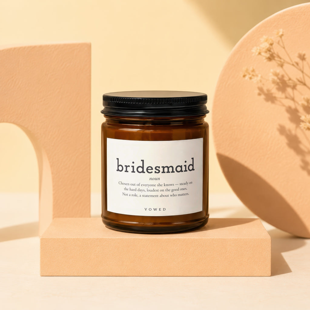 Brown glass candle with "bridesmaid noun" text and definition on white label.