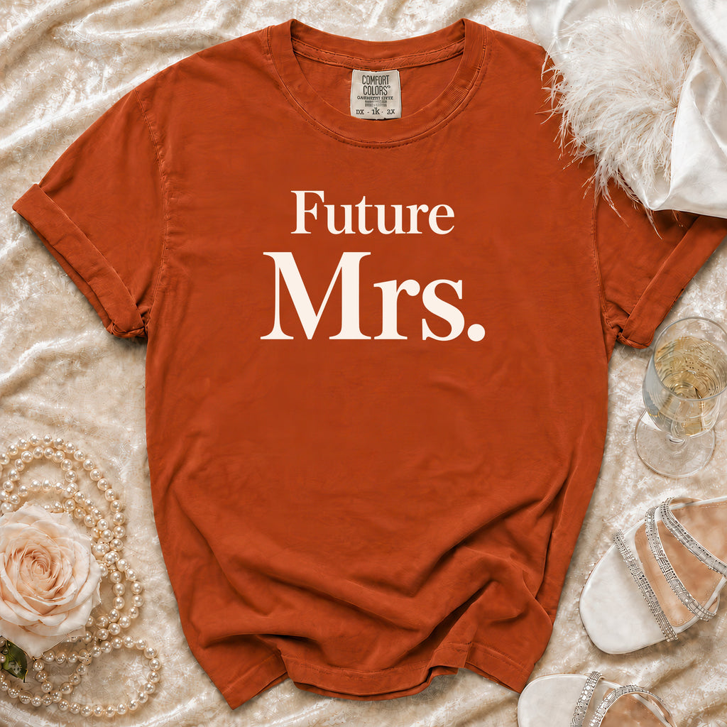 Orange t-shirt with "Future Mrs." text, flat lay with pearls, rose, and shoes.