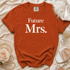 Orange t-shirt with "Future Mrs." text, flat lay with pearls, rose, and shoes.