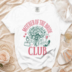 White t-shirt with "Mother of the Bride Club" graphic and bridal accessories.