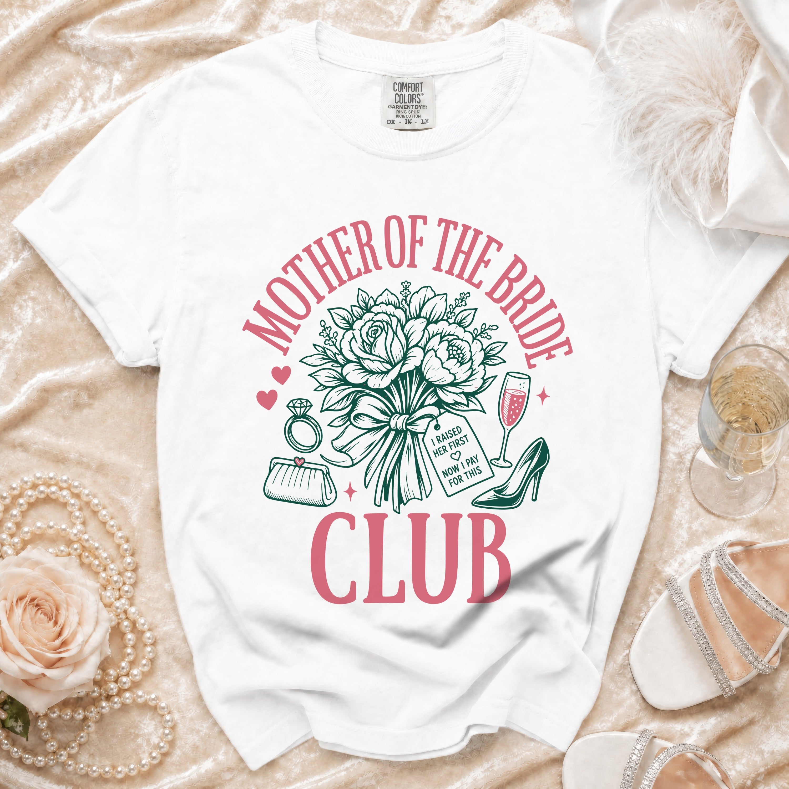 White t-shirt with "Mother of the Bride Club" graphic and bridal accessories.