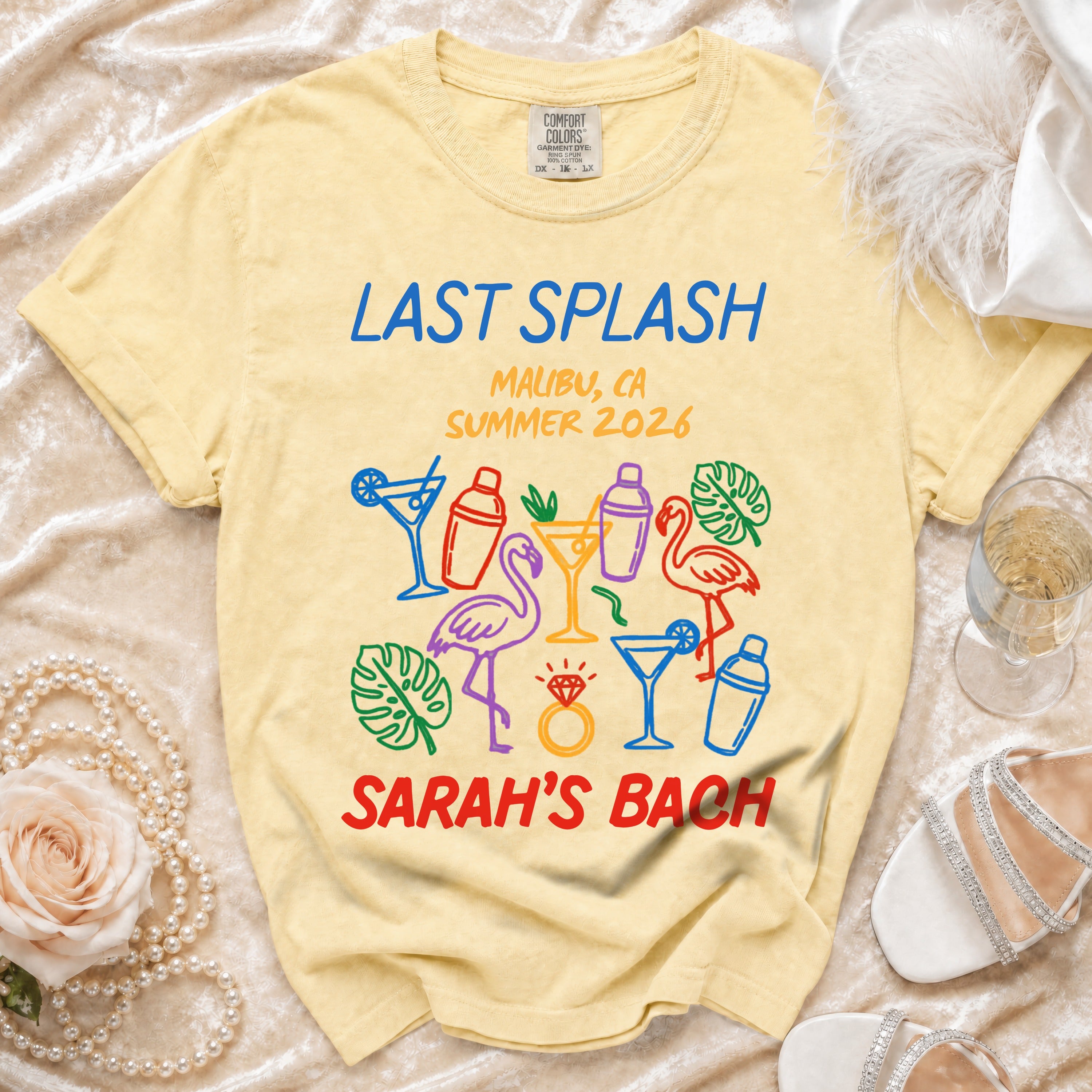 Yellow t-shirt with "Last Splash Malibu, CA Summer 2026 Sarah's Bach" and tropical graphics.