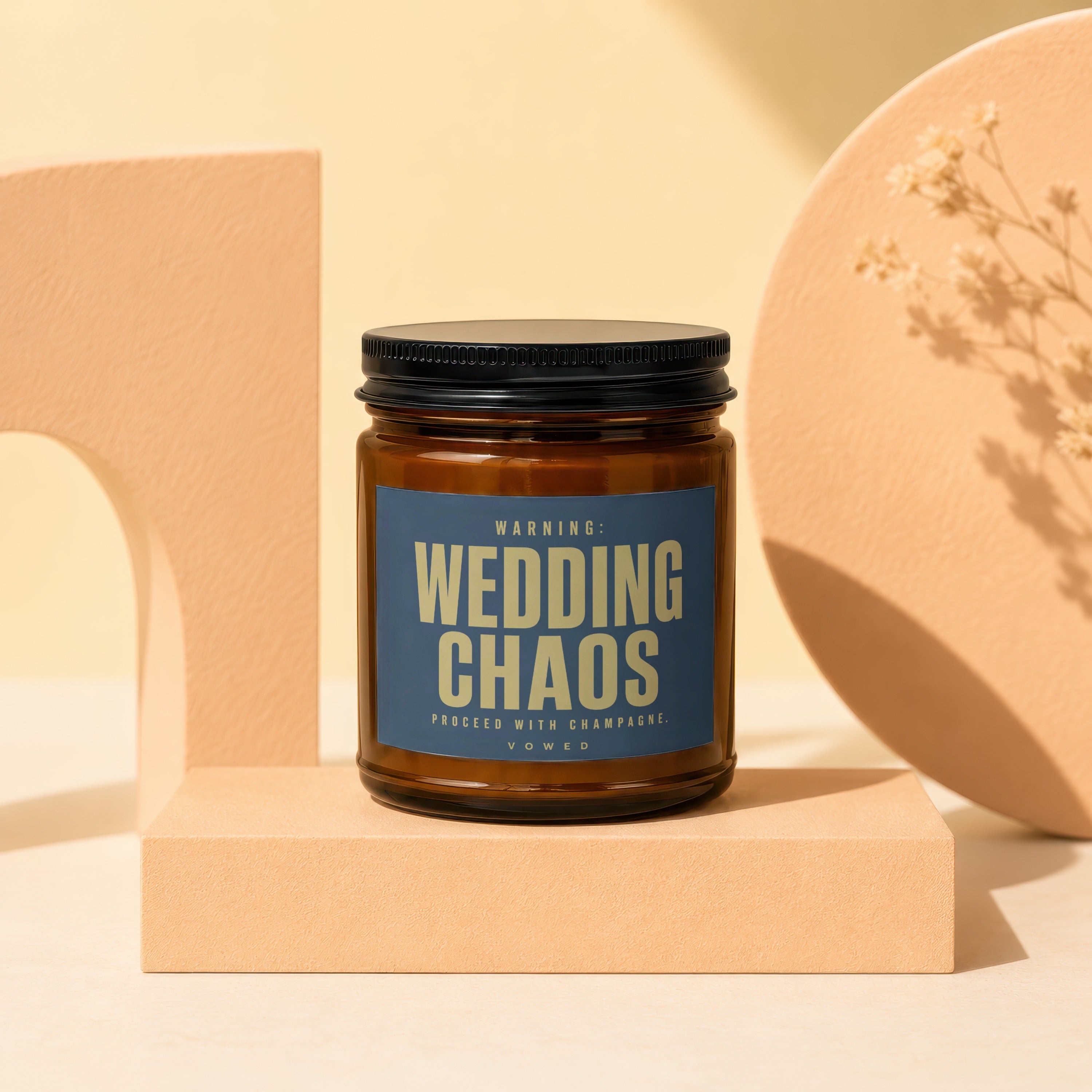 Amber candle labeled "WARNING: WEDDING CHAOS PROCEED WITH CHAMPAGNE. VOWED".