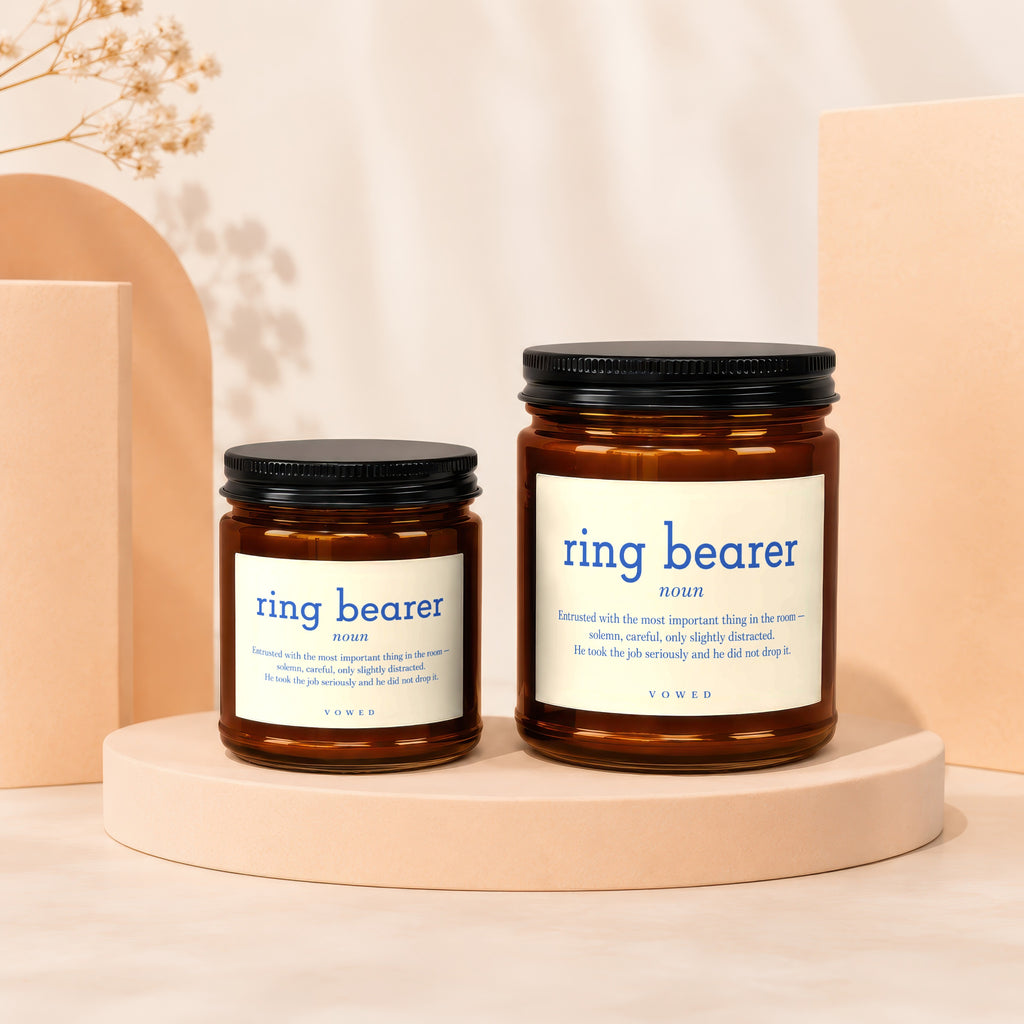 Two amber glass candles with 'ring bearer' text, one smaller than the other.
