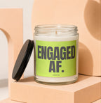 Glass candle with black lid and lime green label that says "ENGAGED AF. VOWED".