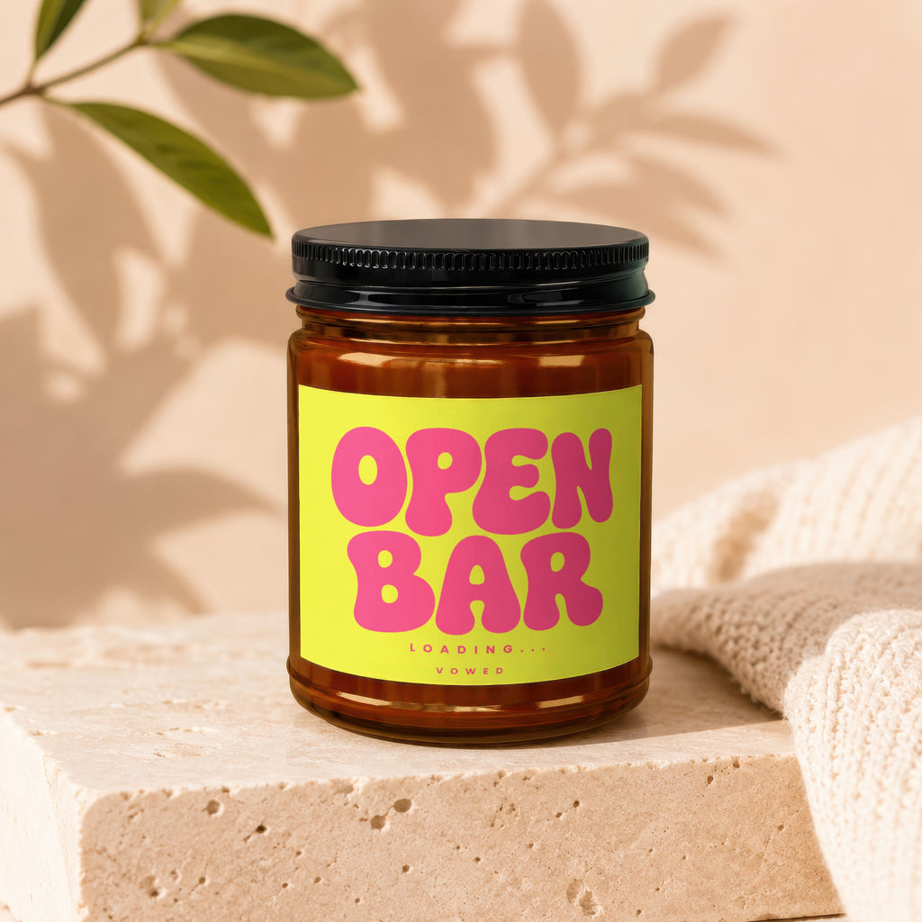 Brown glass jar with black lid and yellow label reading "OPEN BAR LOADING . . . VOWED".