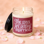 Candle with a lit wick on jar, featuring text "The gays are getting married".