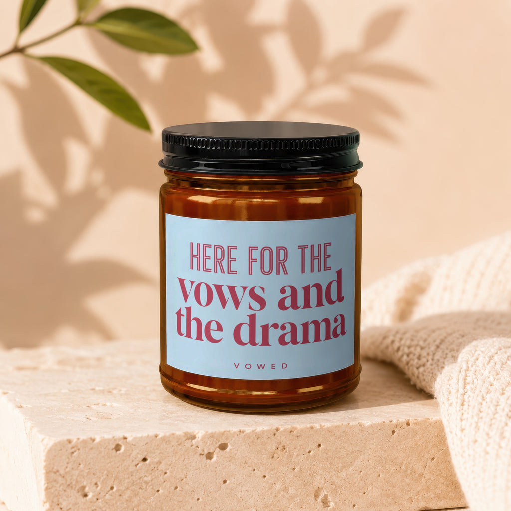 Amber candle in glass jar with "HERE FOR THE vows and the drama" label.