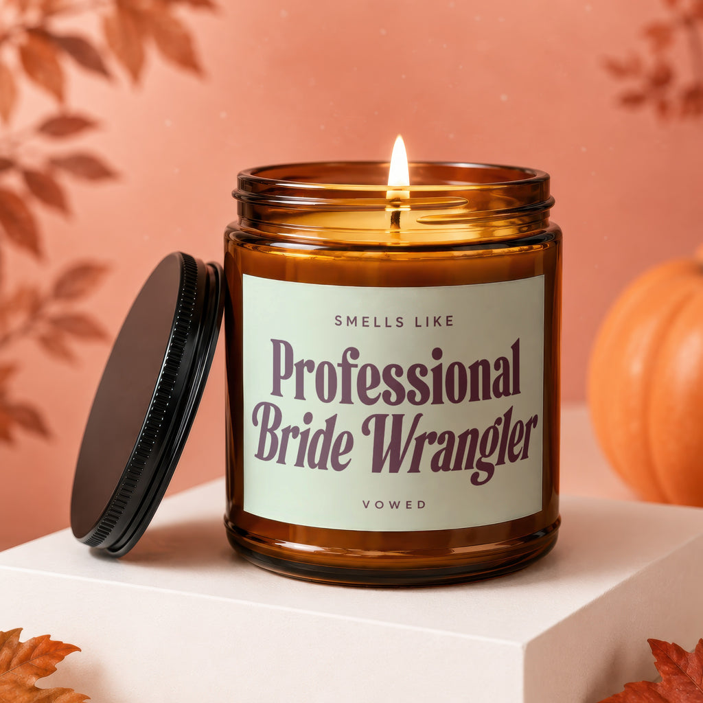 Lit amber candle with "Smells Like Professional Bride Wrangler Vowed" label