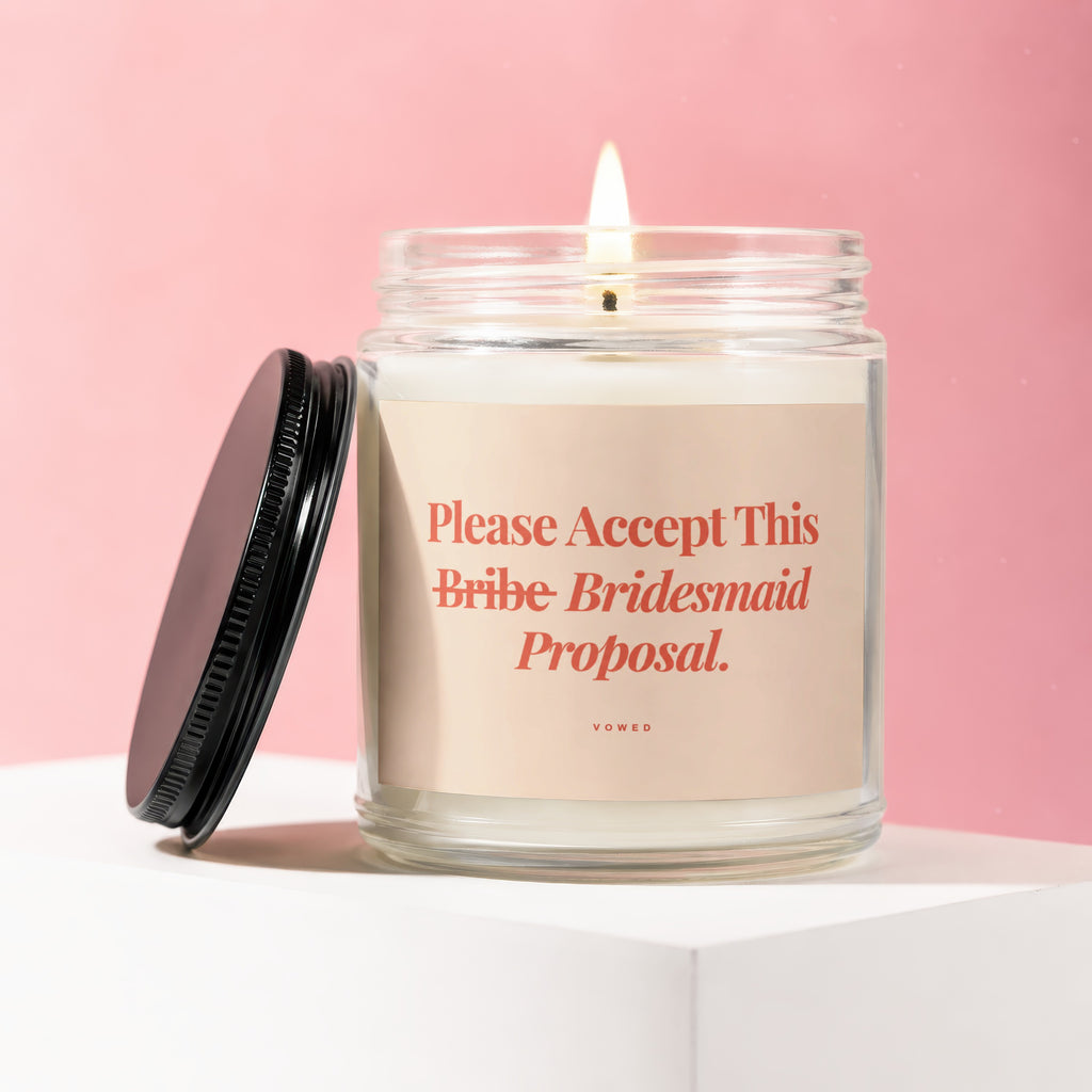Lit candle with "Please Accept This Bribe Bridesmaid Proposal" text.