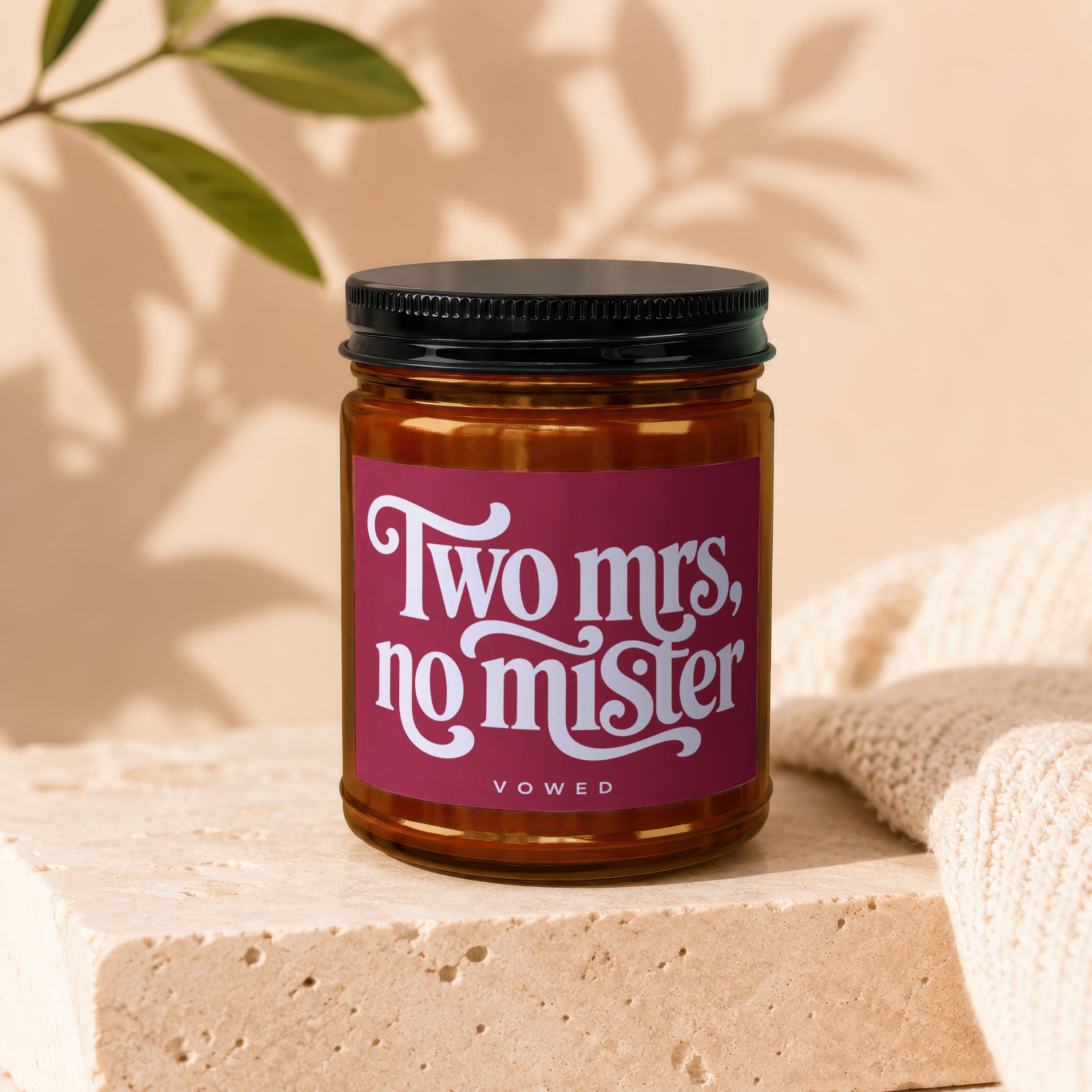 Candle with label "Two Mrs., no mister" and "vowed" below.