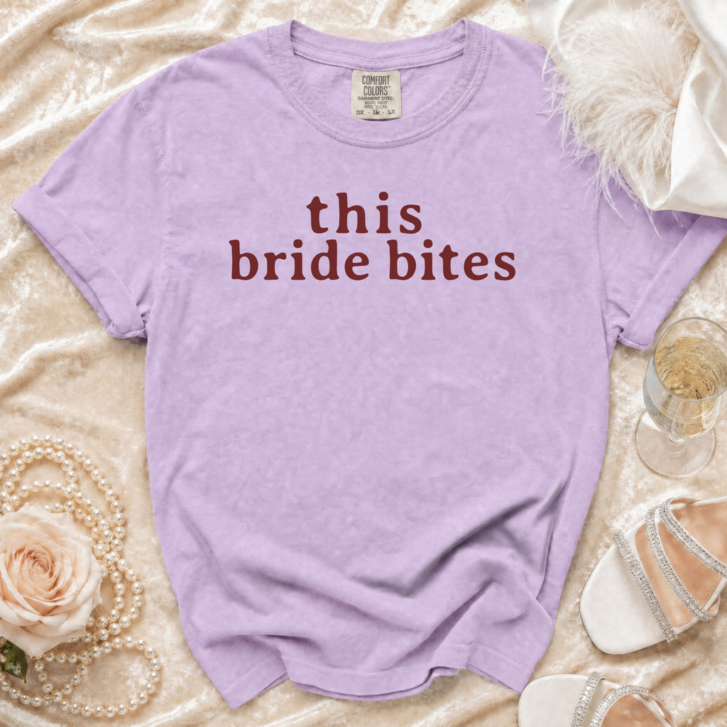 Lavender Comfort Colors t-shirt with "this bride bites" text in burgundy.