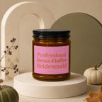 Amber jar candle with pink label reading "Professional Dress Fluffer Bridesmaid"