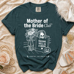 Dark green shirt with "Mother of the Bride Club" text and skull graphics.