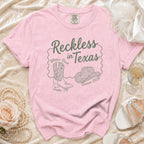 Pink t-shirt with "Reckless in Texas" design for Olivia's Bach in Austin, TX.