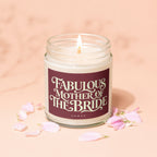 Candle with "Fabulous Mother of The Bride" text in a jar, surrounded by petals.