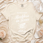 Cream t-shirt for Olivia's Bach "Reckless in Texas" Austin, TX Summer 2026.
