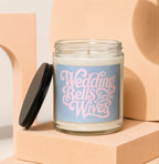 Glass candle with "Wedding Bells for the Wives" text on its label.