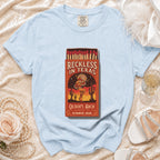 Light blue t-shirt with "Reckless in Texas" matchbox graphic.