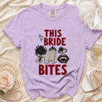 Purple t-shirt with "THIS BRIDE BITES" text and vampire-themed graphics.