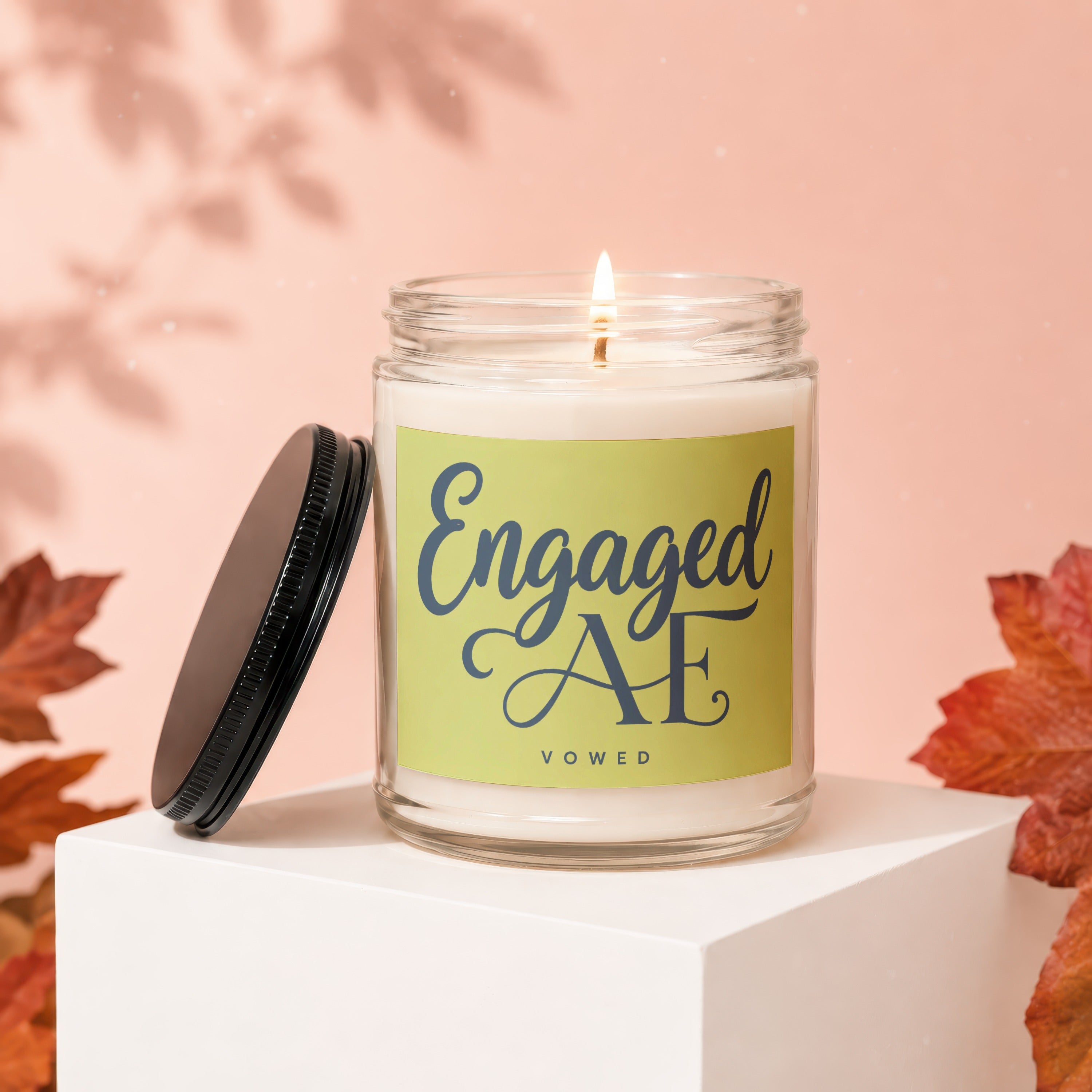 Candle with "Engaged AE VOWED" text on a light green label.