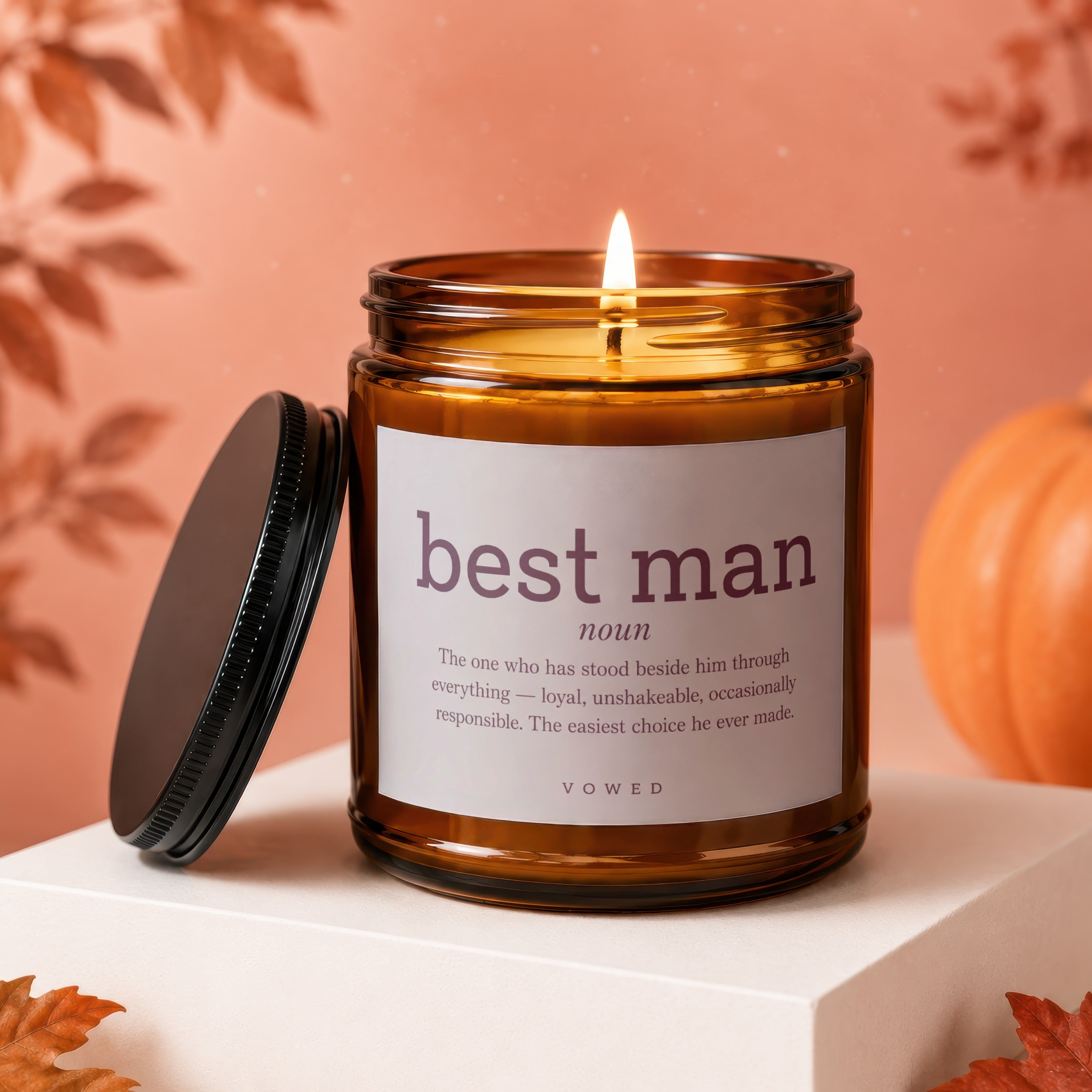 Amber candle labeled "best man noun" with descriptive text, lid removed.