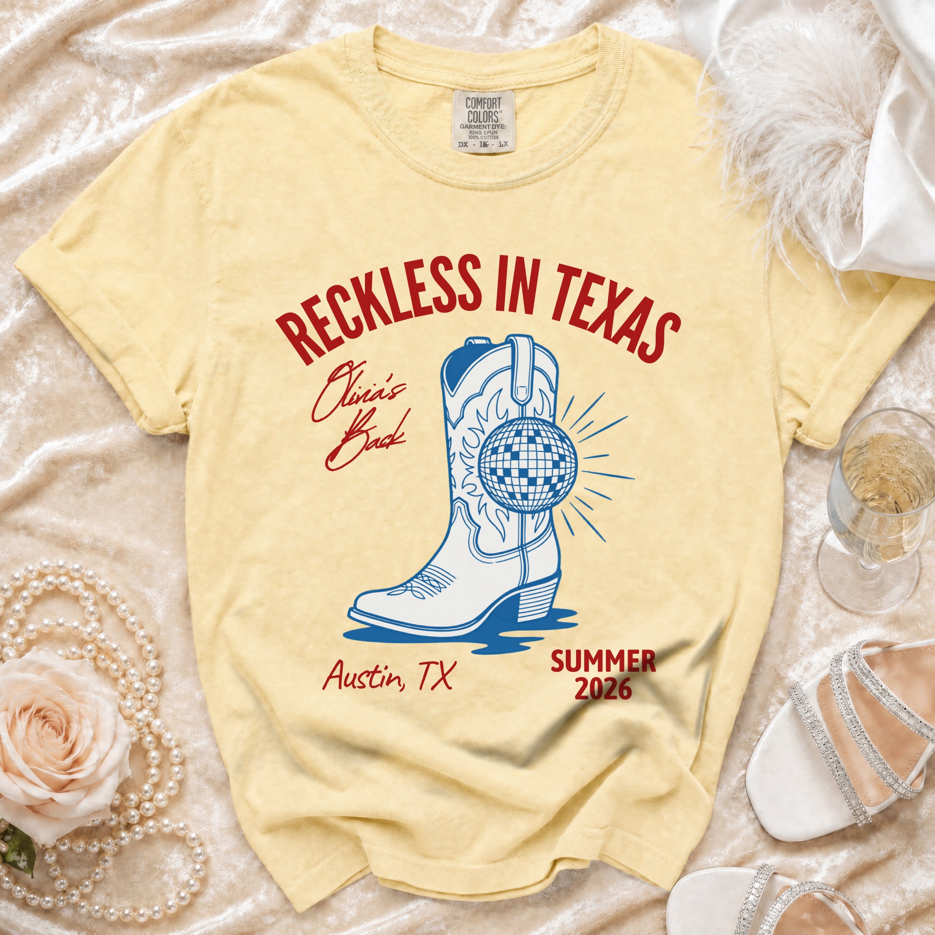 Yellow t-shirt with "Reckless in Texas" graphic and cowboy boot.