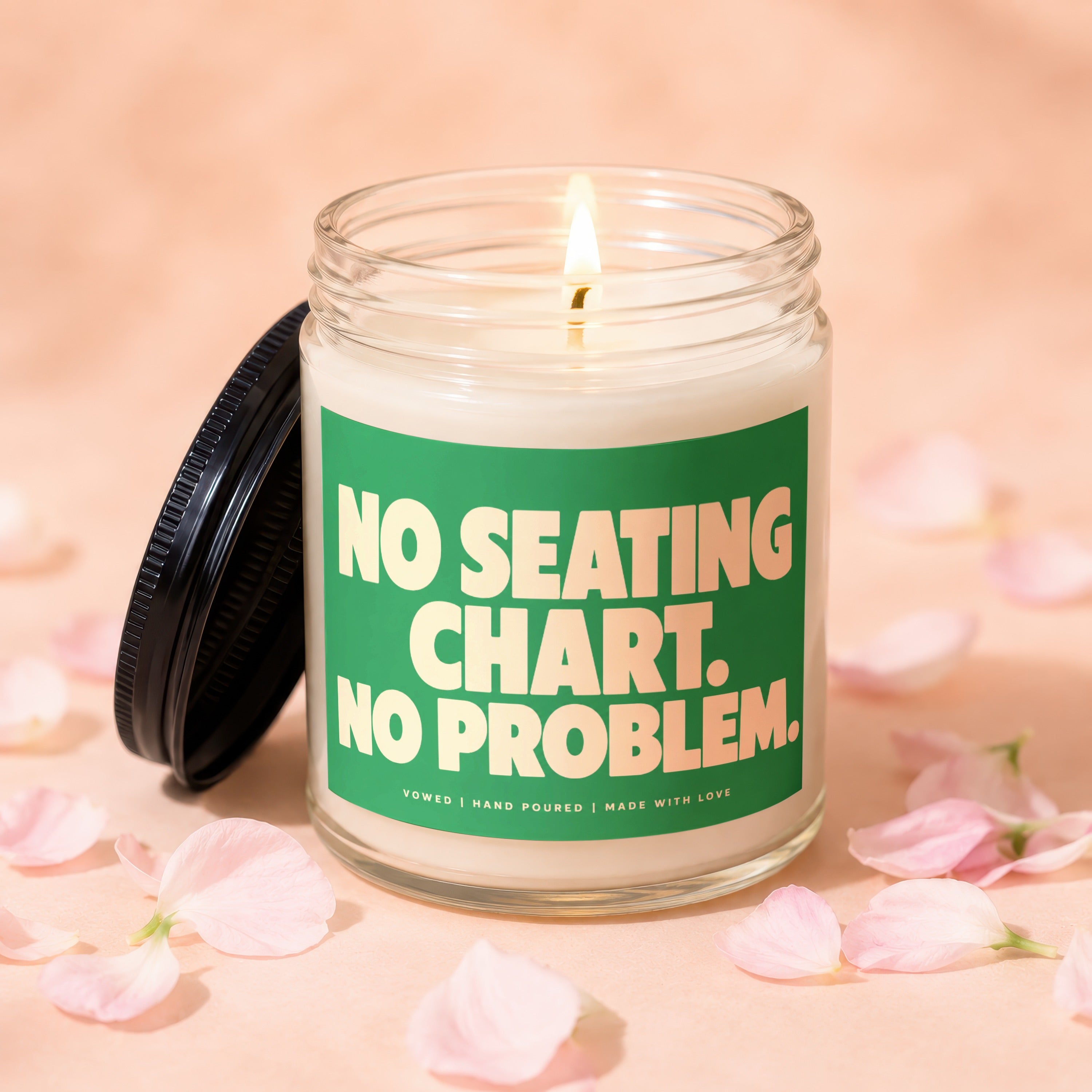 Lit candle in glass jar with "NO SEATING CHART. NO PROBLEM." text.