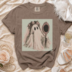 Ghost bride applying lipstick in ornate mirror, on brown Comfort Colors t-shirt.