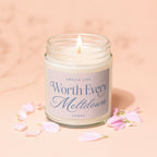 Candle with a lit wick, label reads "Smells Like Worth Every Meltdown Vowed".