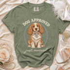 Green t-shirt with illustration of dog holding bib with rings and text "DOG APPROVED just married".