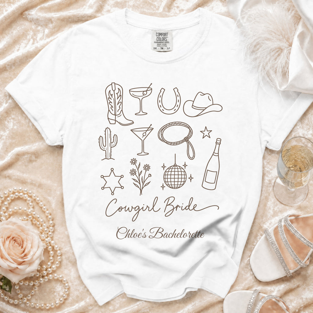 White t-shirt printed with brown outline icons and the text Cowgirl Bride Chloe's Bachelorette.