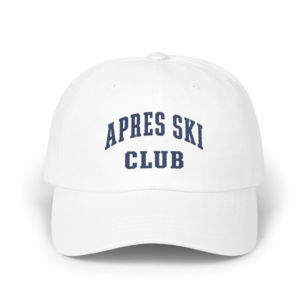 A white baseball cap featuring blue embroidered text that reads APRES SKI CLUB across the front panels.