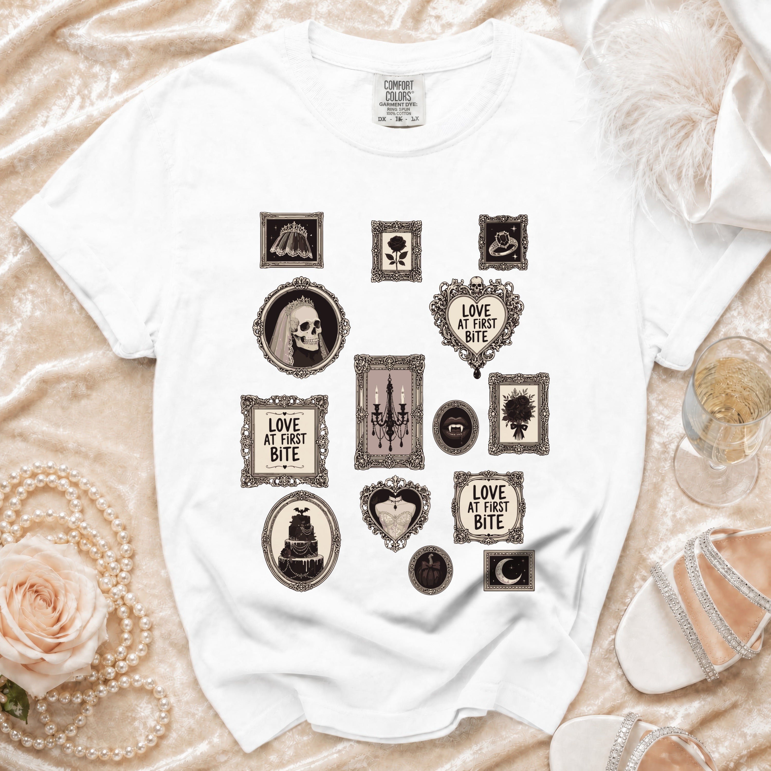 White t-shirt with Gothic-themed framed prints including skulls, roses, and cake.