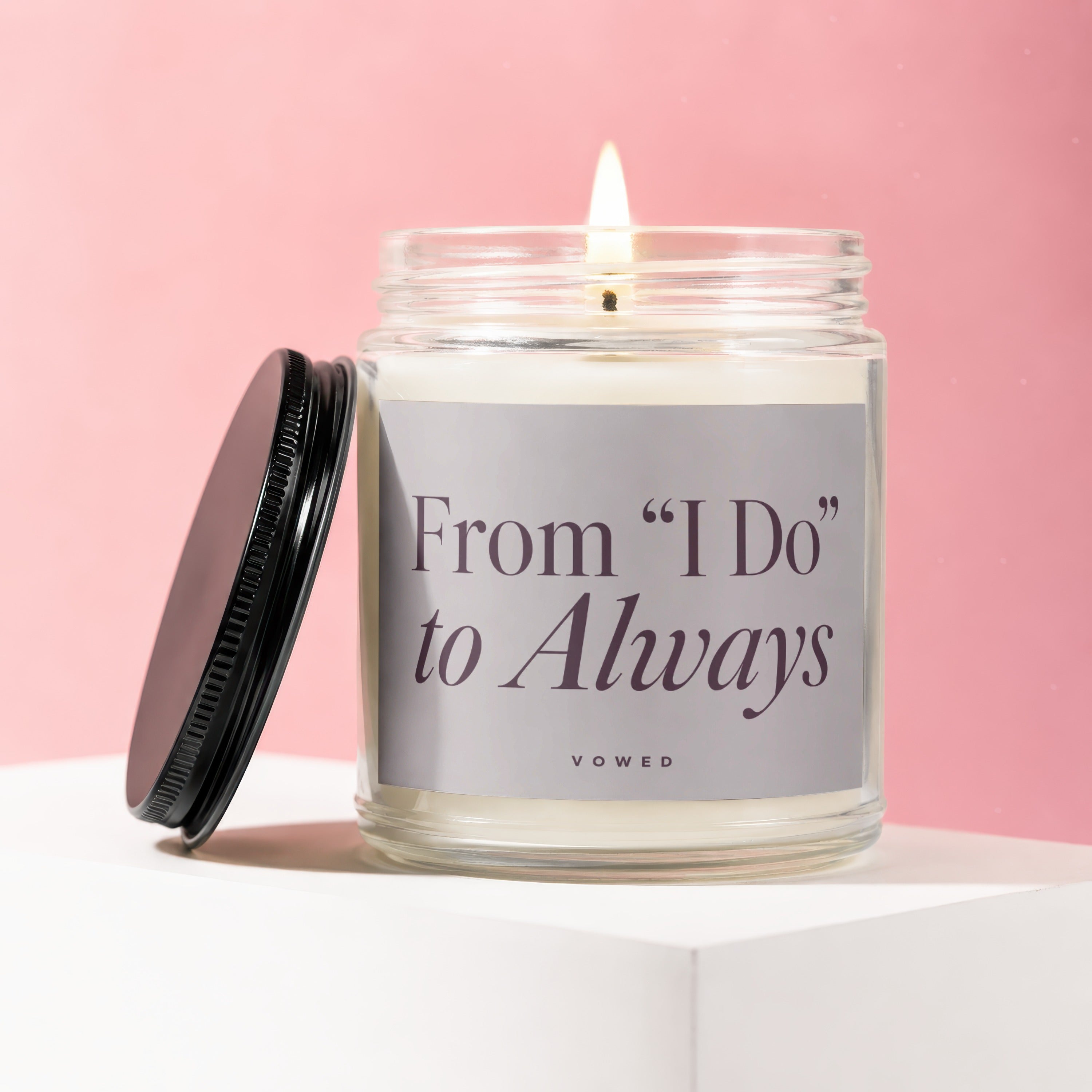 Candle with lit wick and "From 'I Do' to Always" text on label.