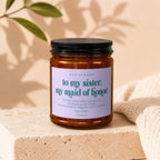Candle with text "to my sister, my maid of honor" and a loving message.