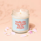 Lit candle in a jar with text "Smells Like Your Fiancé Hit the Jackpot."