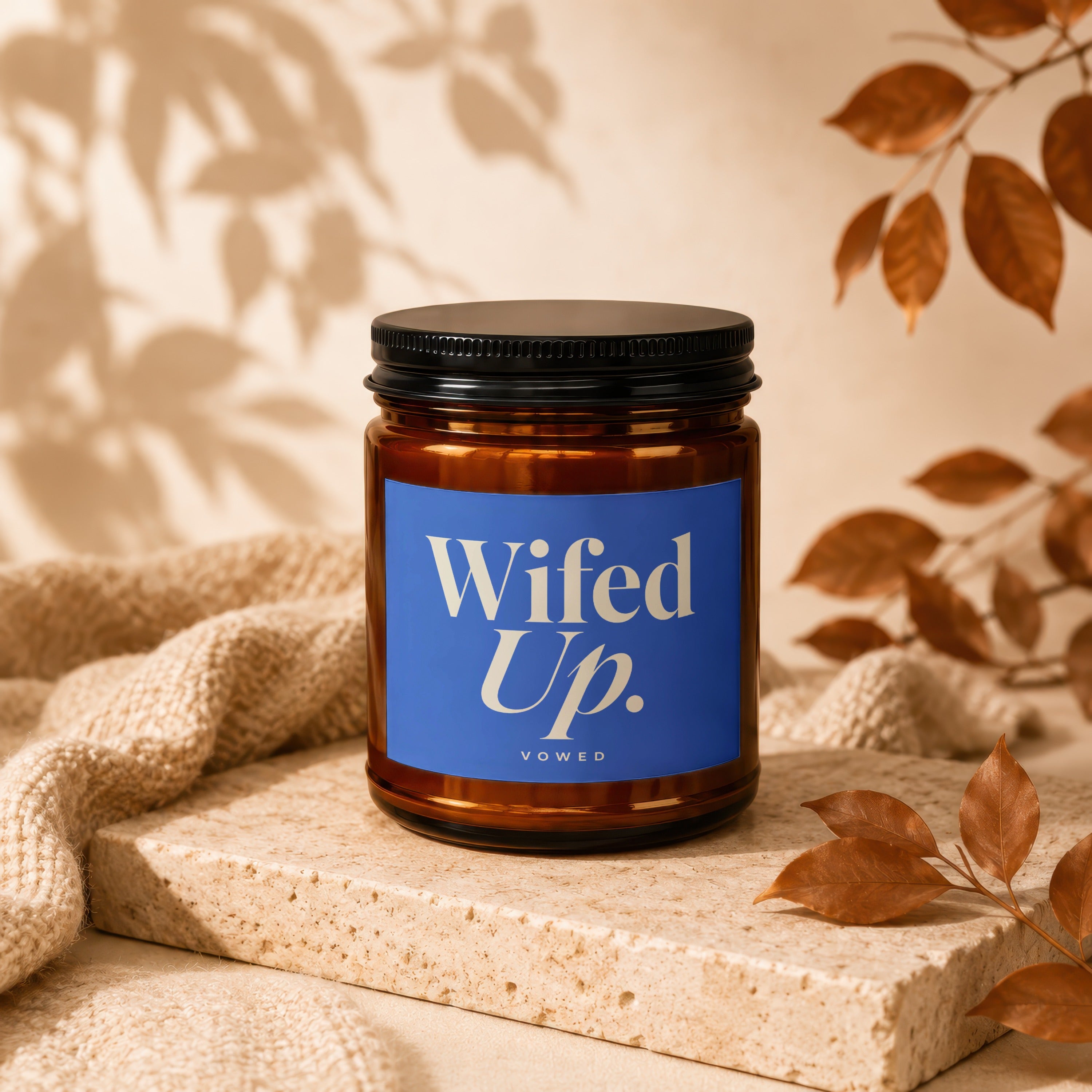 Brown candle with blue label reading "Wifed Up. Vowed."