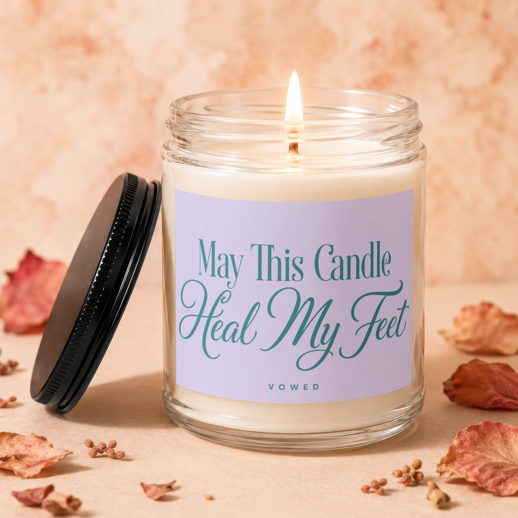 Lit candle in glass jar with label "May This Candle Heal My Feet Vowed".