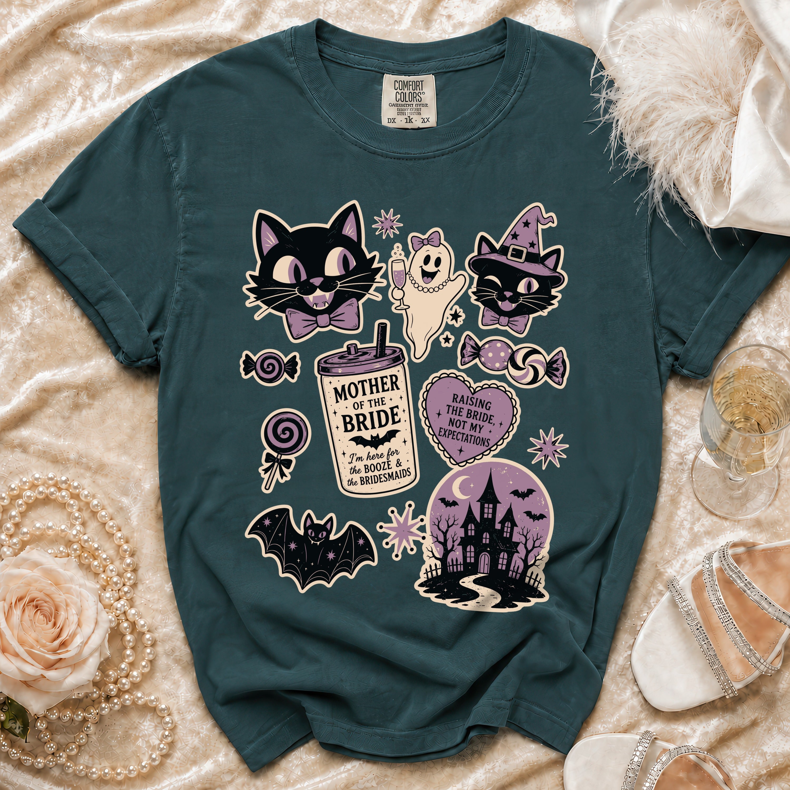 Teal t-shirt with Halloween-themed graphics including cats, ghost, and haunted house.