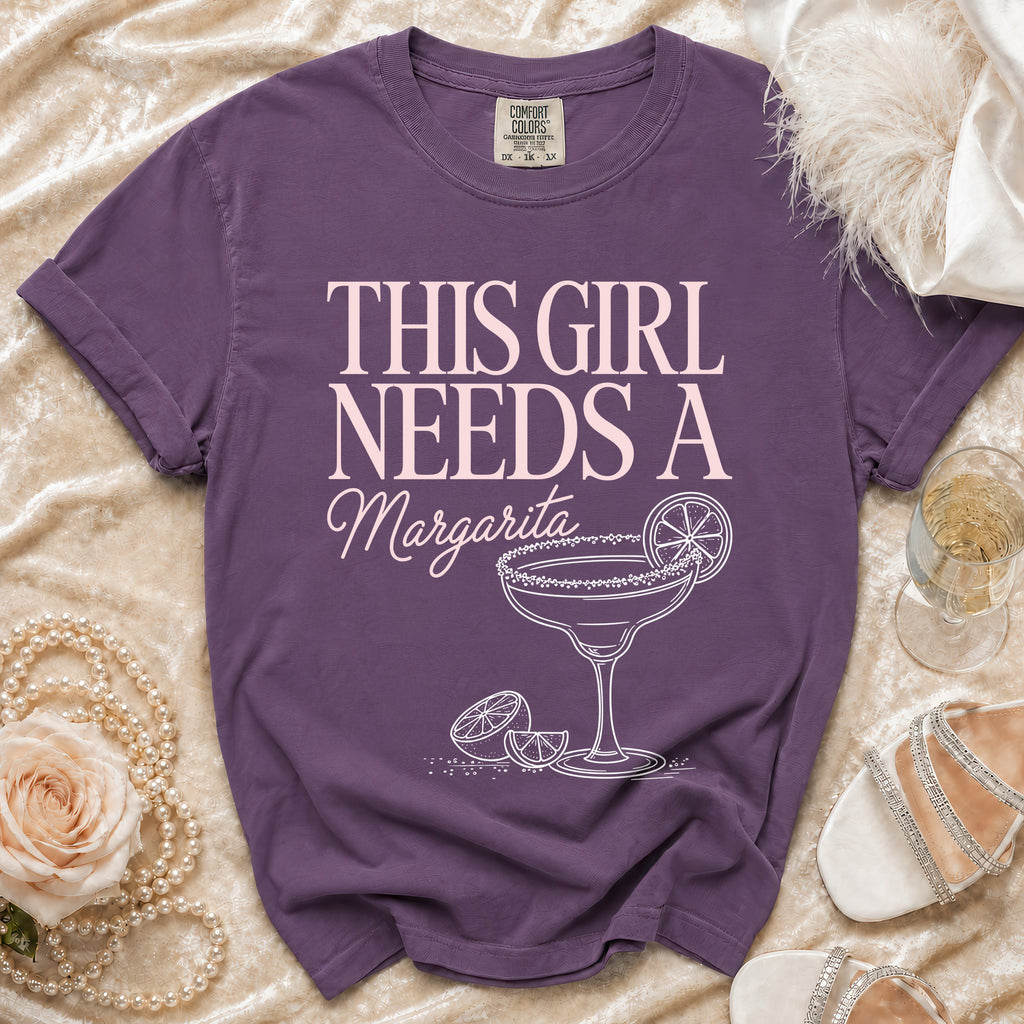 Purple t-shirt with "This Girl Needs a Margarita" text and cocktail graphic.